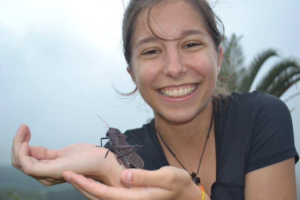 Lindsey Ferguson holding insect outside on cloudy day