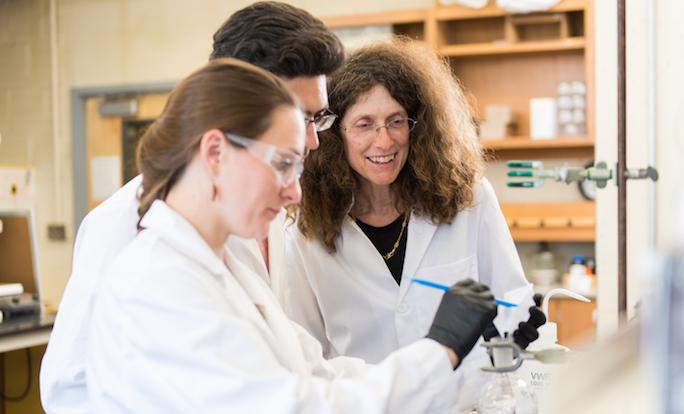 May Nyman in the lab with students