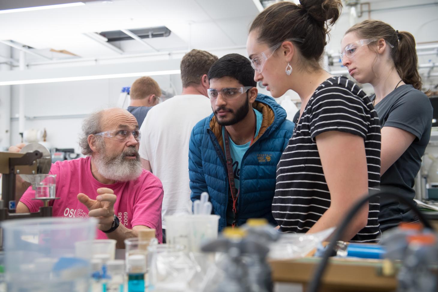professor helping students in lab
