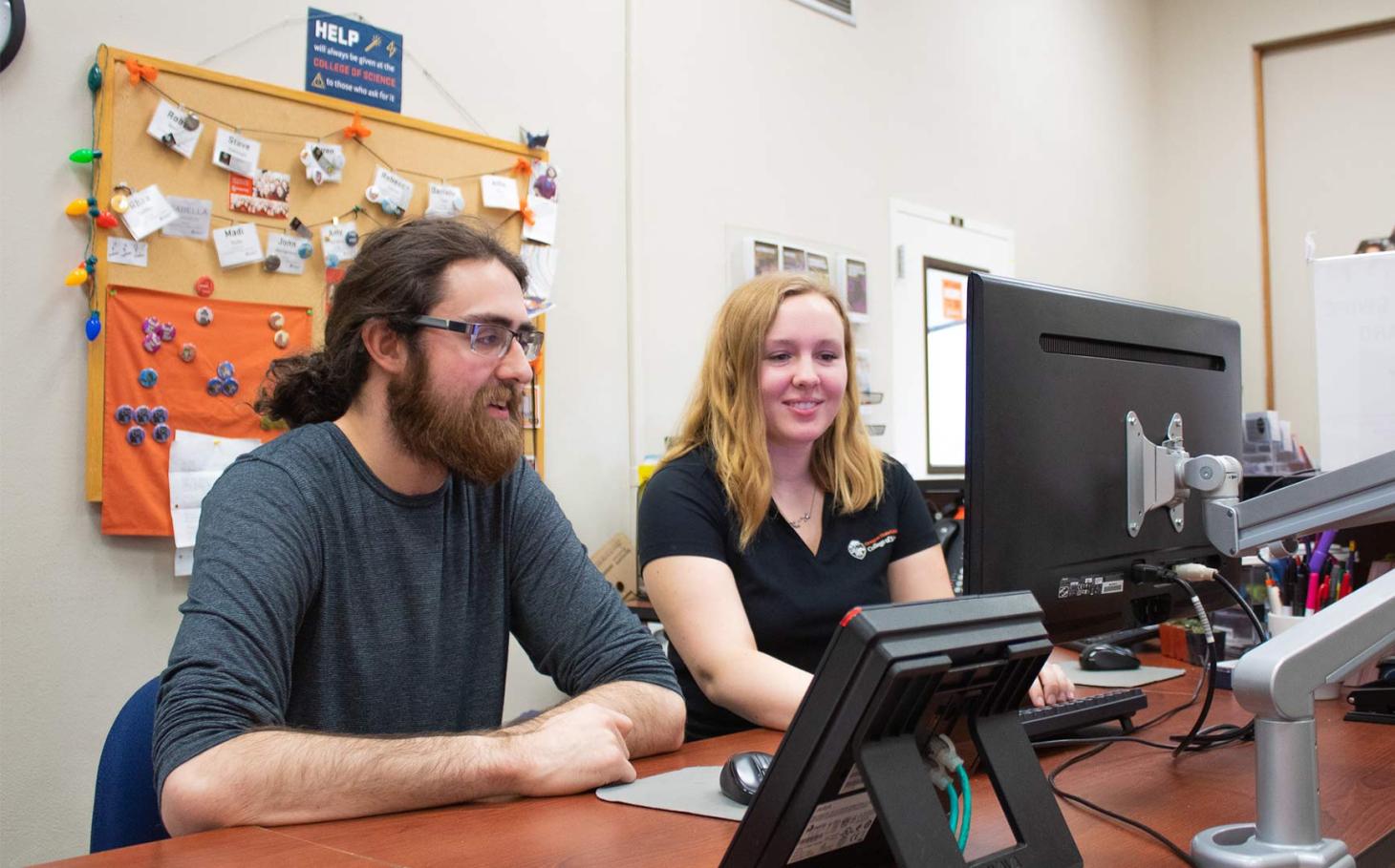 Steve Dobrioglio and Madeline Bloom working on computer in the science success center