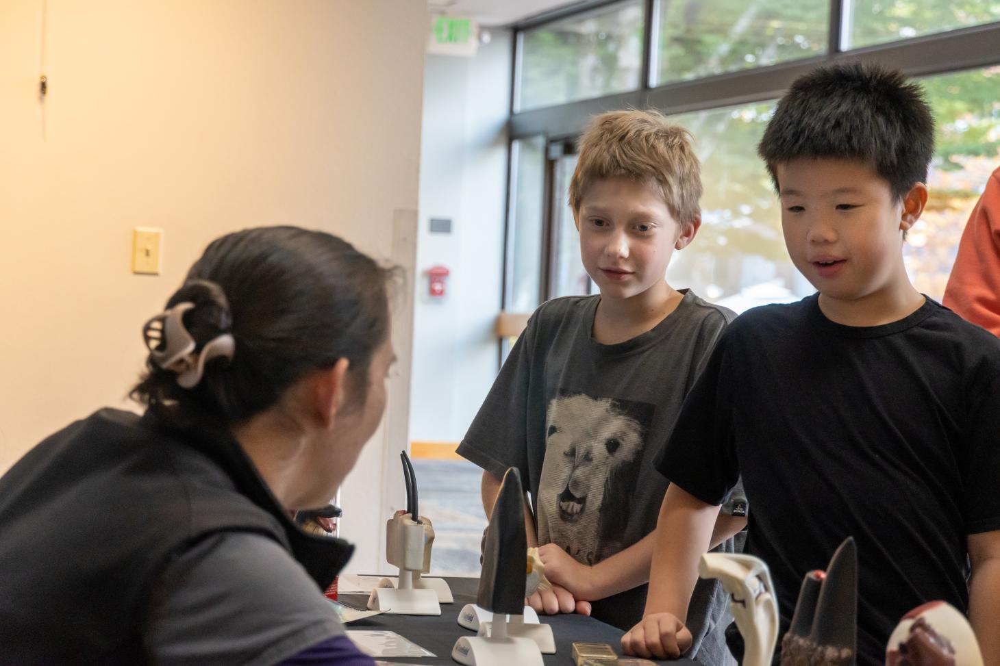 Elementary students interact with individuals from the Carlson College of Veterinary Medicine.
