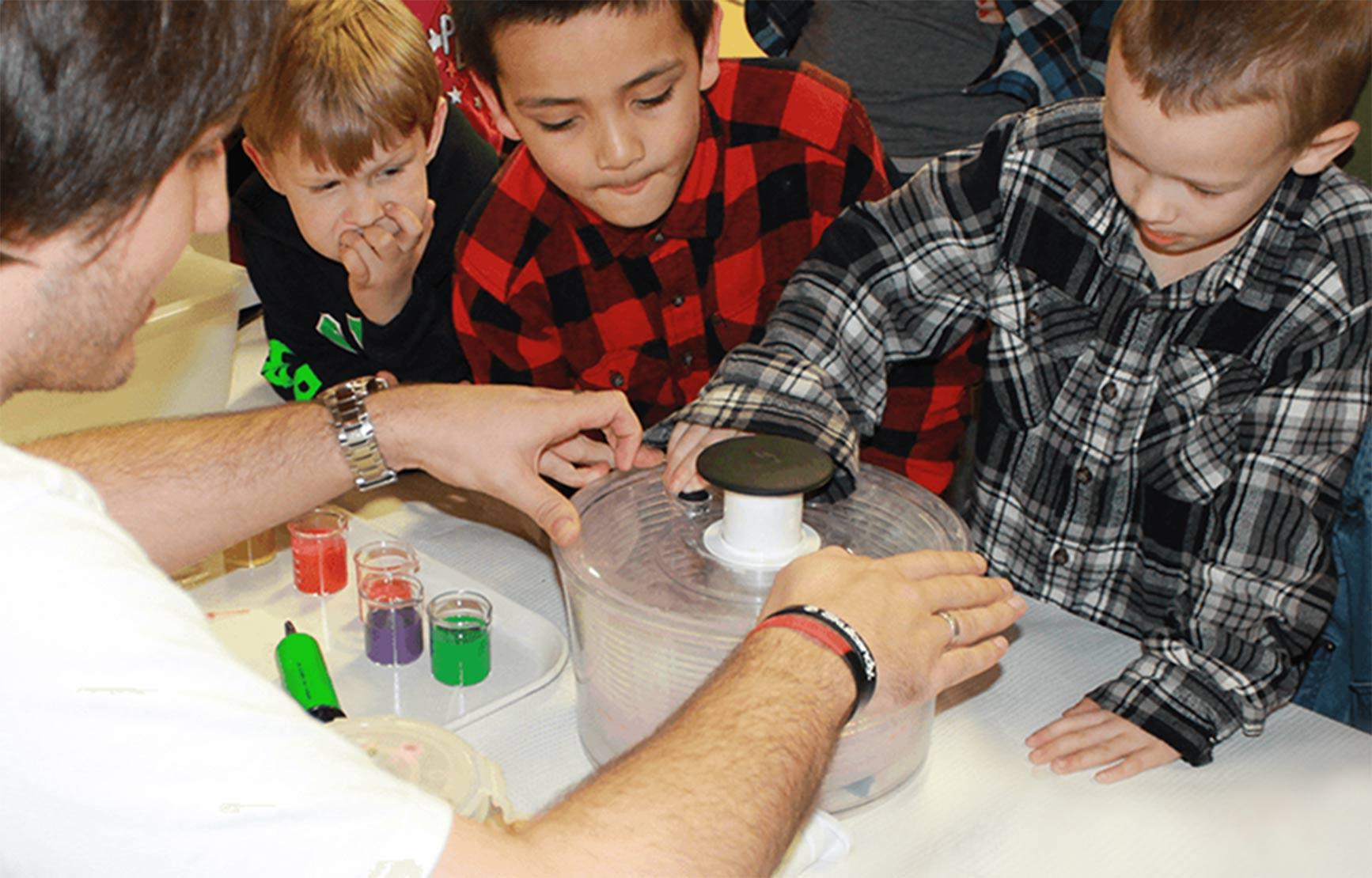 Children looking at science booth