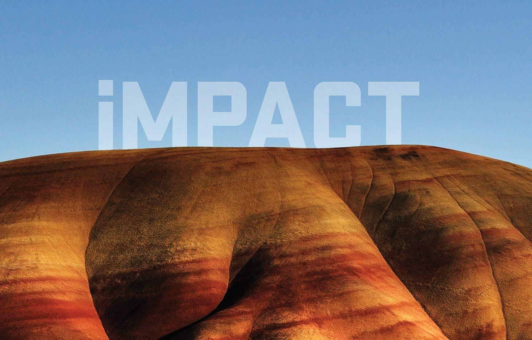 IMPACT title peering over sandy desert hill