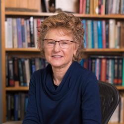 Lisa Ganio sitting in front of bookshelf