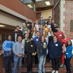 A group of individuals stand on a staircase for a photo during a mathematics conference.