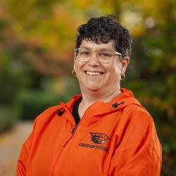 Dean Eleanor Feingold smiling in orange Oregon State jacket