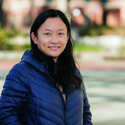 Lan Xue smiles for a headshot wearing a puffer jacket.
