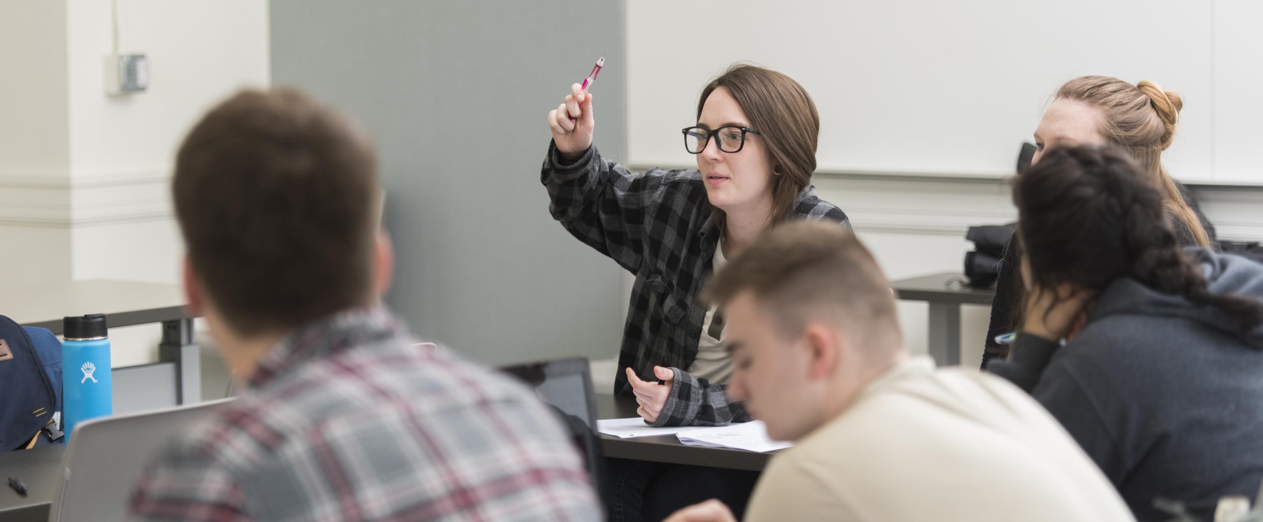 female student raising her hand in class