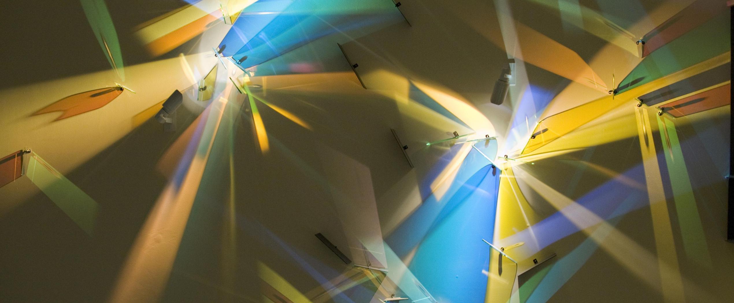 Glass art piece reflecting light from wall