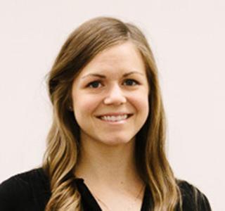 Courtney Rae Armour in front of white backdrop