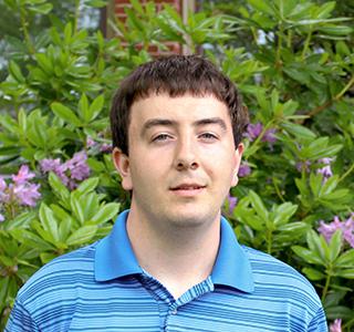 Jonathan Van Why in front of Kidder Hall