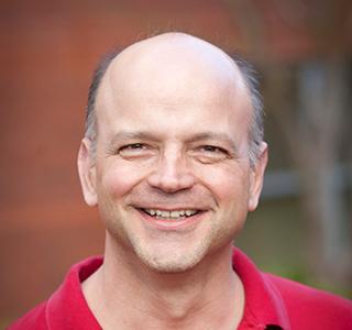 Steve Sloop in front of brick building