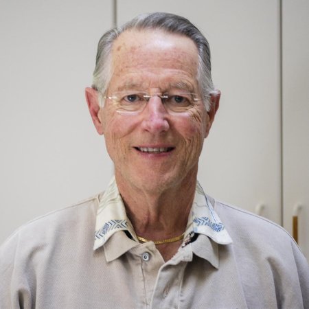 A man in grey shirt poses for photo.
