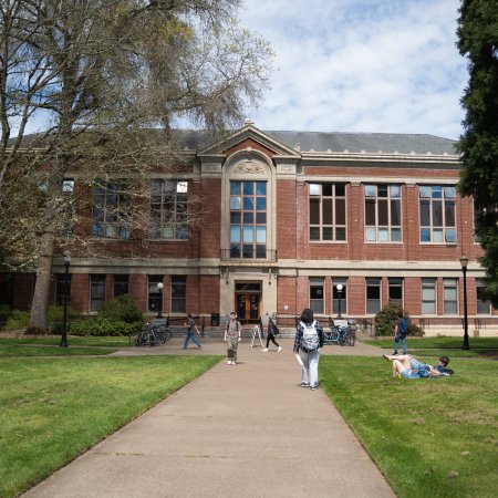 Photo of brick building, Kidder Hall, with students walking to class.
