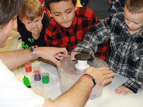 Children looking at science booth