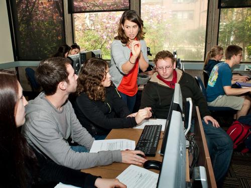 professor helping students in computer lab