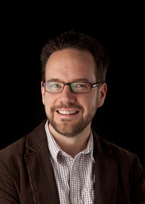 Daniel Myles in front of black backdrop