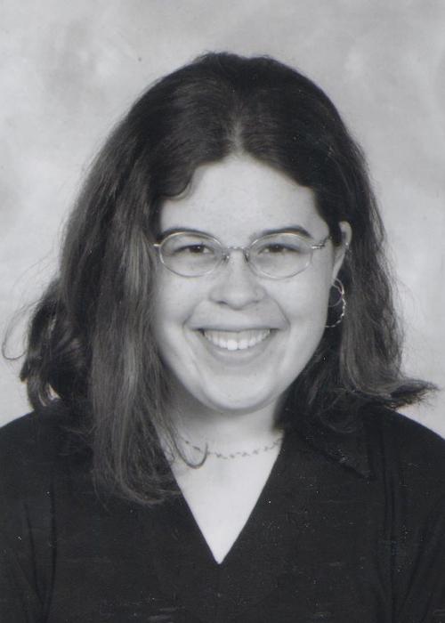 black and white photo of Emily Simpson in front of white backdrop