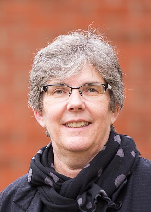 Heidi Schellman in front of brick wall