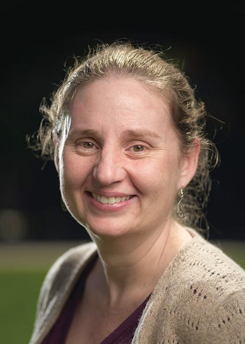 Liz Gire in front of black backdrop