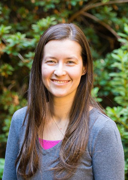 Stephanie Bollmann in front of shrubbery