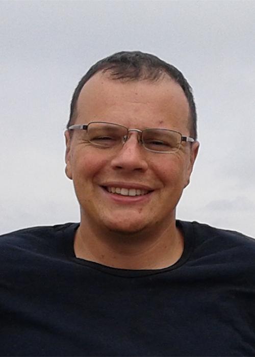 Yevgeniy Kovchegov standing outside on cloudy day