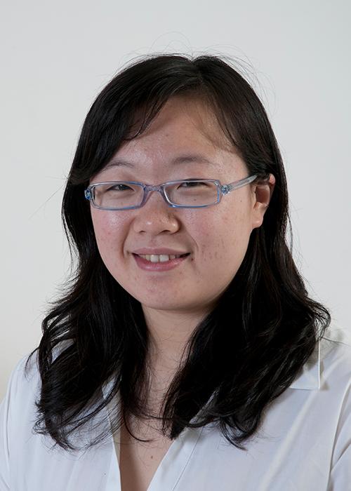 Jie Zhang in front of white backdrop