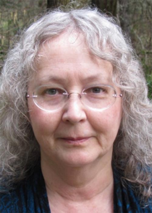 Kathryn Hadley in front of shrubbery