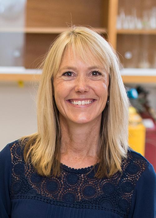 Kim Halsey sitting in lab