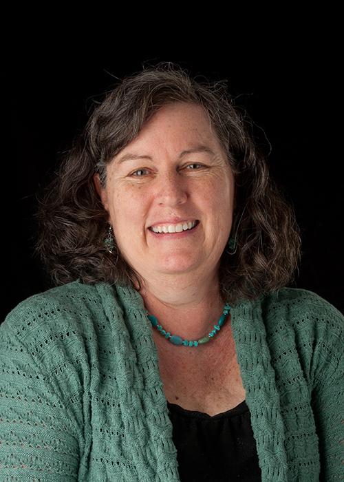 Margie Haak in front of black backdrop