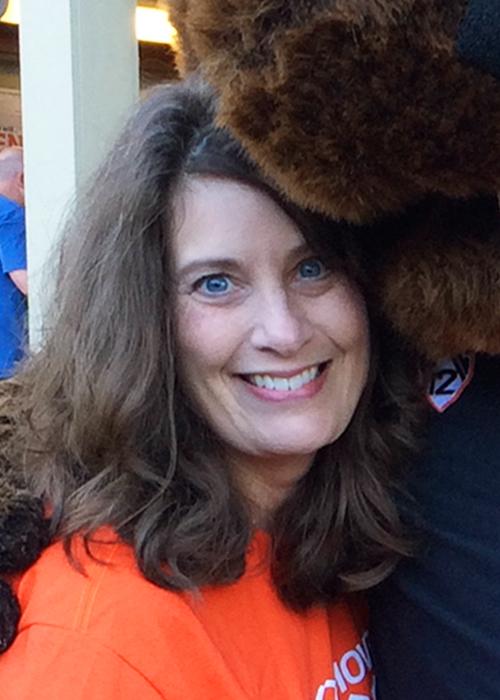 Kim McQueen hugging Benny the Beaver