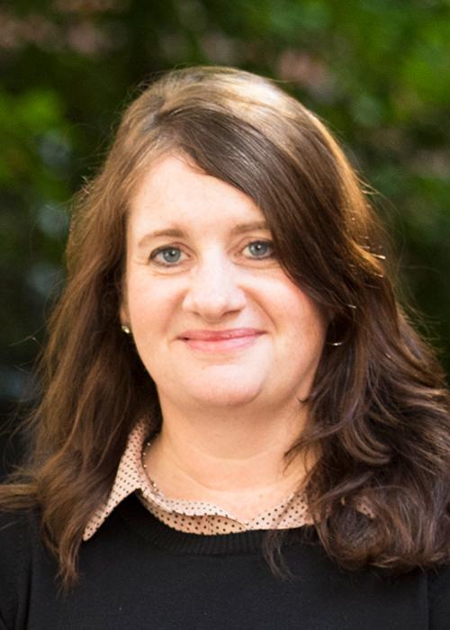 Jennifer Olarra in front of shrubbery