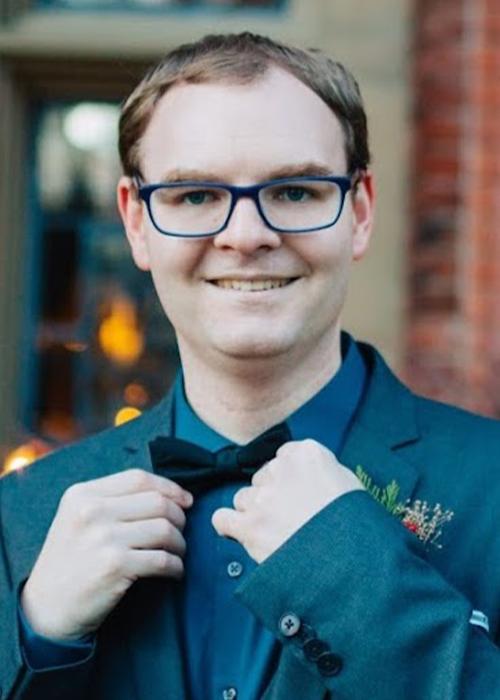 Paul Emigh outside adjusting his bowtie