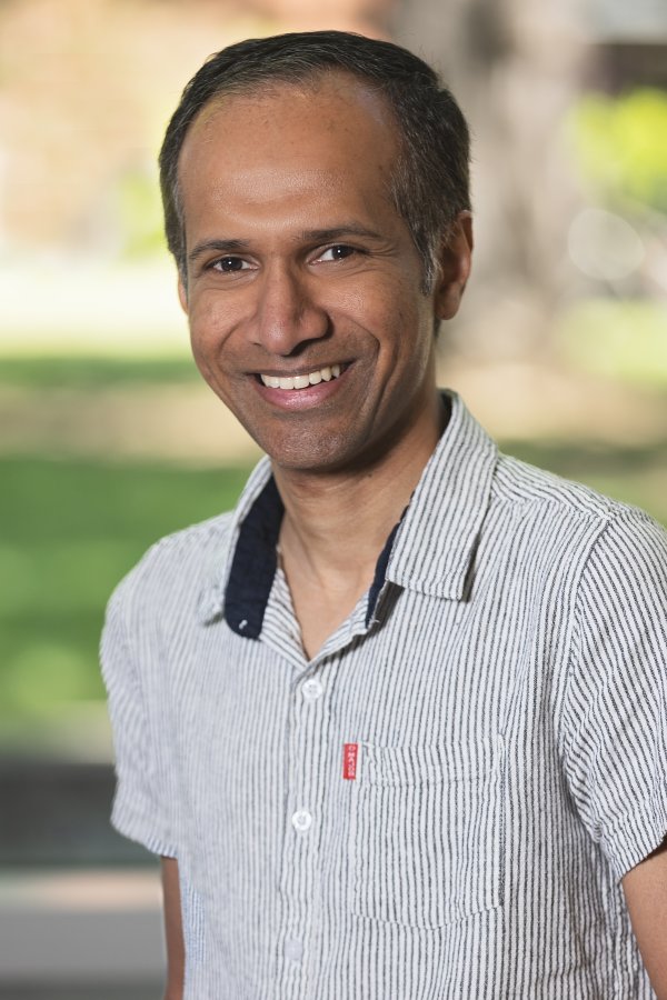 Instructor Amila Liyanage smiling on campus