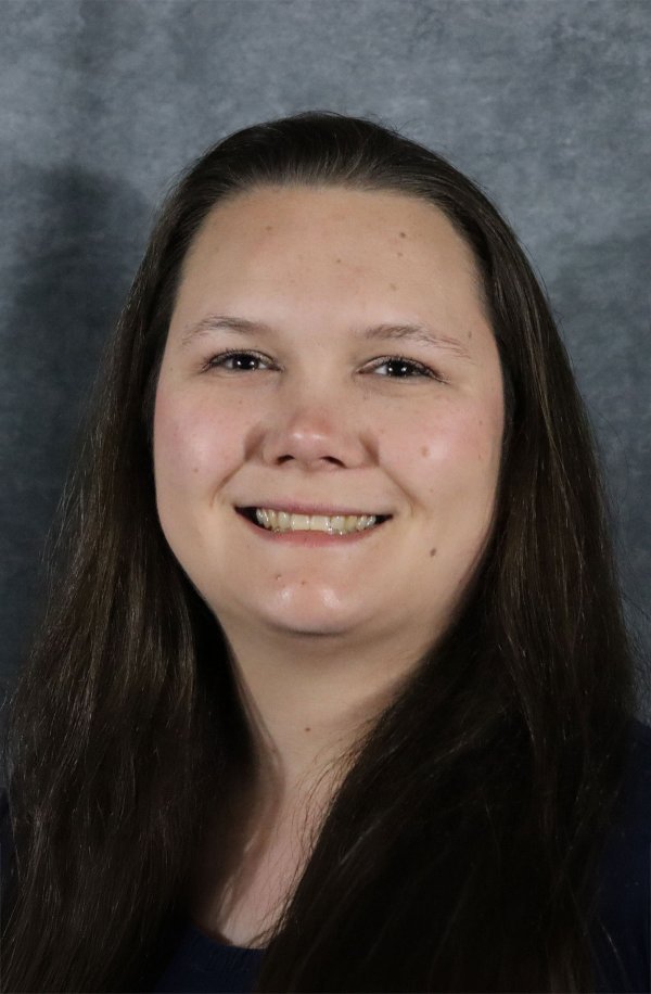 Smiling headshot of Nikki on a studio background