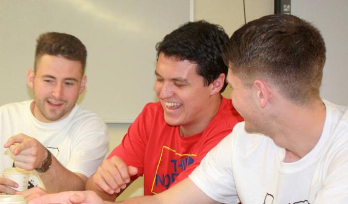 Male students interacting with data fest booth