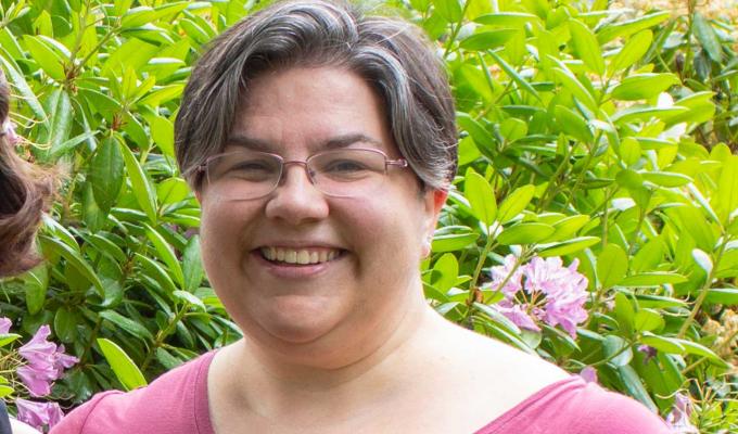 Emerald Stacy in front of shrubbery