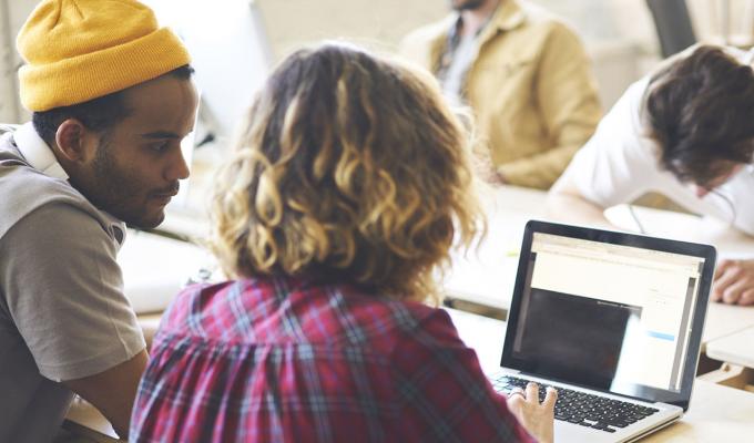 students working on their laptops in study room