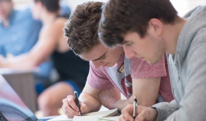 Two students studying together in classroom