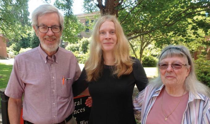 Isabelle Logan with Chris and Kate Mathews standing outside campus