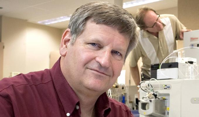 Joe Beckman in his lab with colleagues