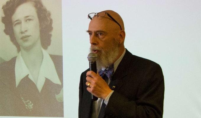 Dr. Charles Hays lecturing in front of big screen