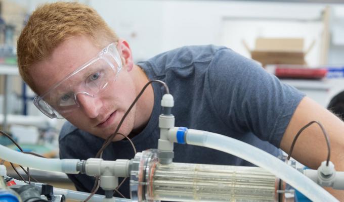 male student working with lab equipment