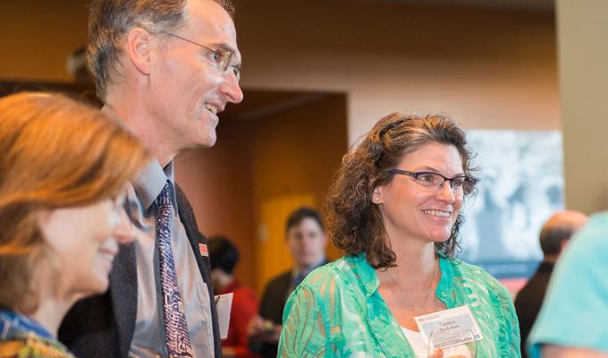 Faculty chatting with one another
