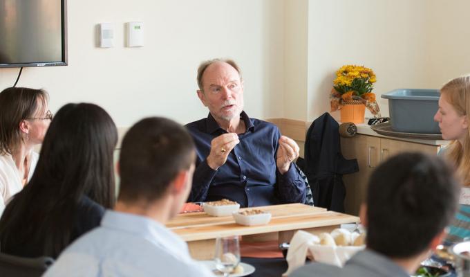 Joel Peterson talking to science staff in meeting
