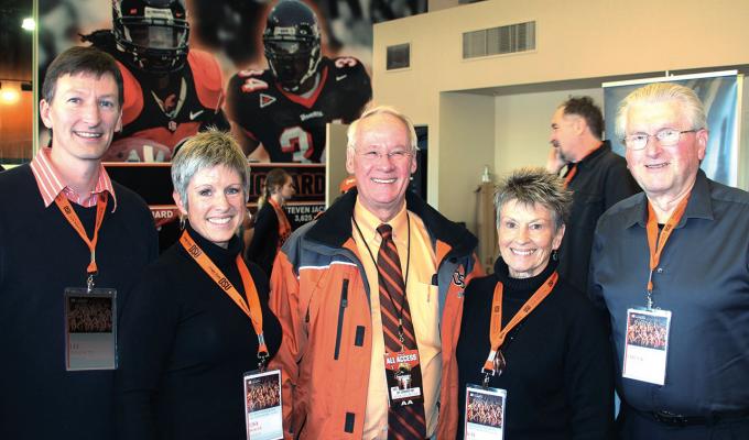 Chuck and Kay Merrill with Ed Ray taking group photo at University Day
