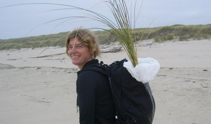 Sally D. Hacker walking though sand dune