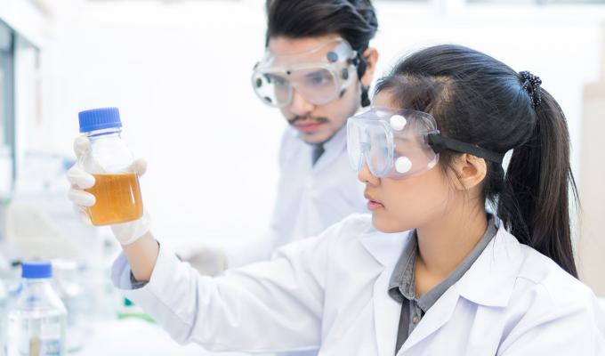 students analyzing beakers in lab