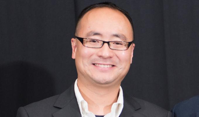 Chong Fang in front of black backdrop