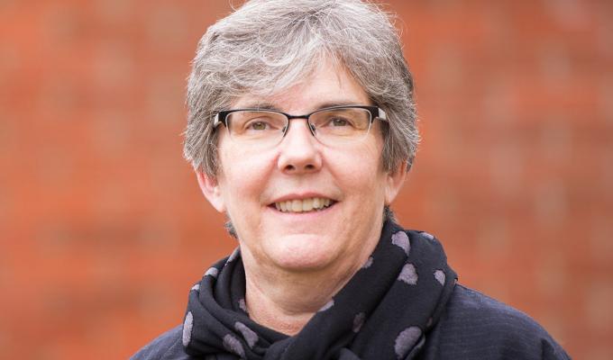 Heidi Schellman in front of brick wall